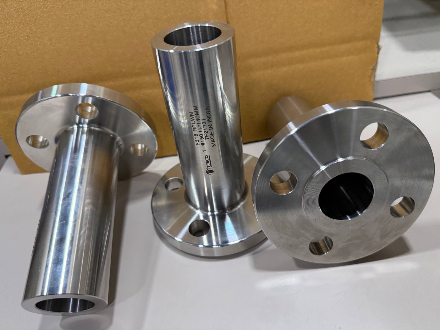 Three ASTM A182 F316 RFLWN long weld neck flanges 1 inch 150 class with 140 mm barrels, heat TF21737, laser marked by Tesco