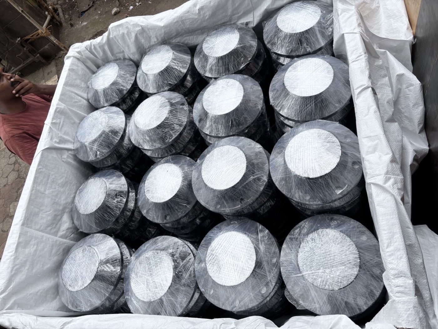 Black-coated ASTM A105 carbon steel flanges wrapped and packed in a lined crate for export by Tesco Steel & Engineering