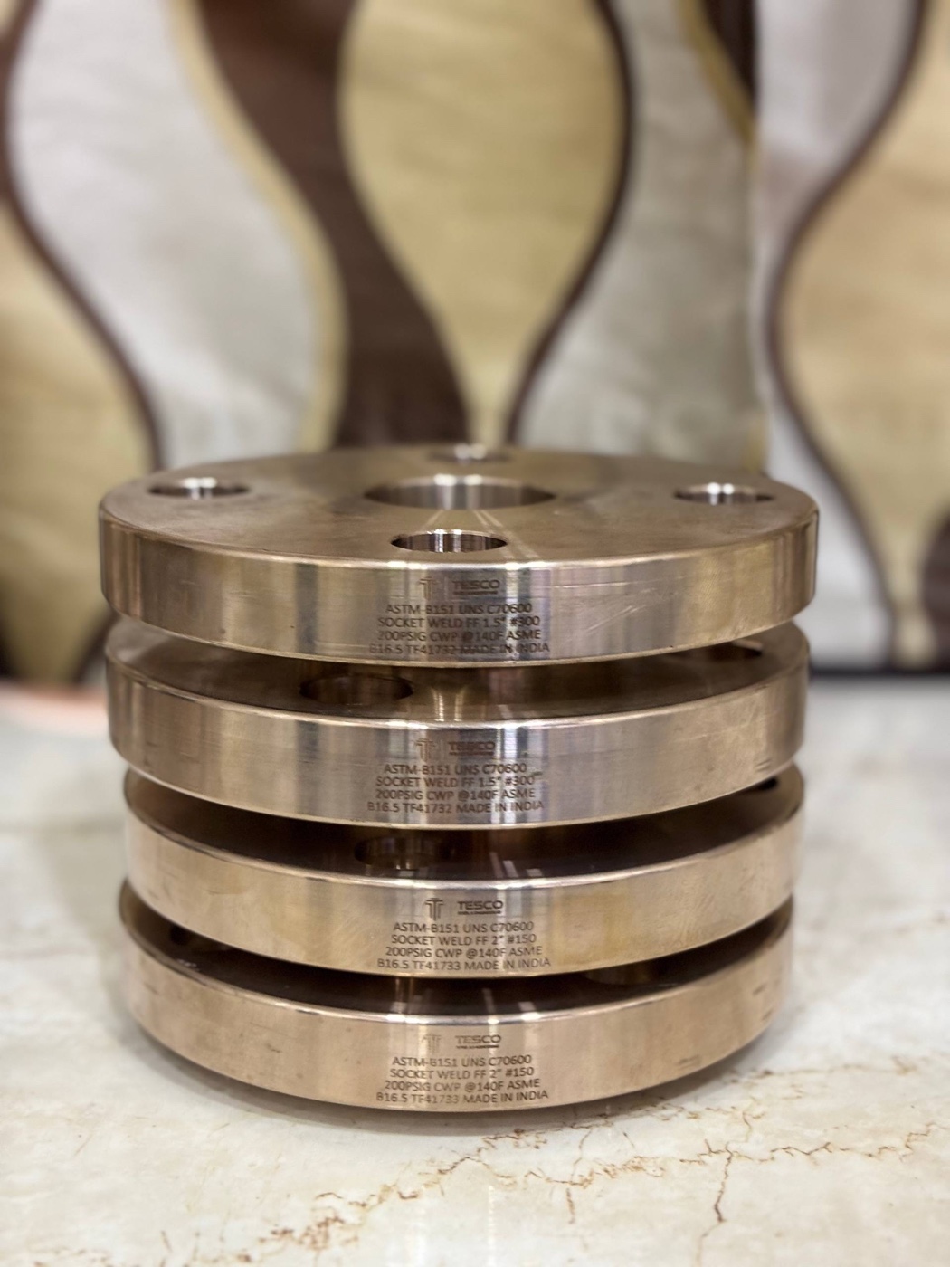 Stack of ASTM B151 C70600 copper nickel socket weld flat face flanges 1.5 inch and 2 inch laser marked by Tesco