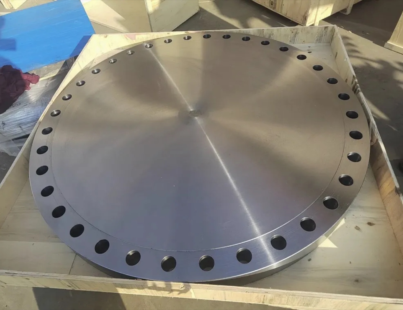 Large diameter BLRF blind raised face flange in wooden export crate at Tesco Steel & Engineering, India