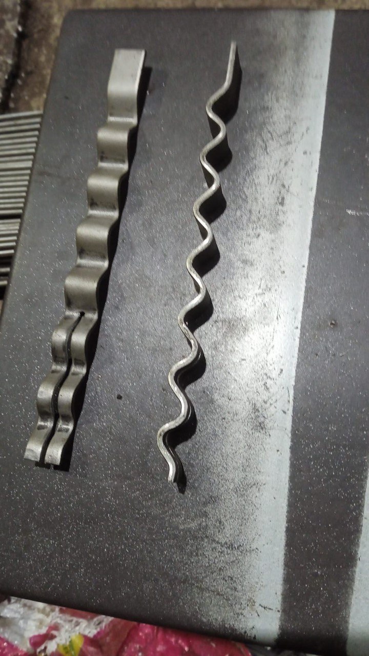 Corrugated refractory anchor strips on the workbench