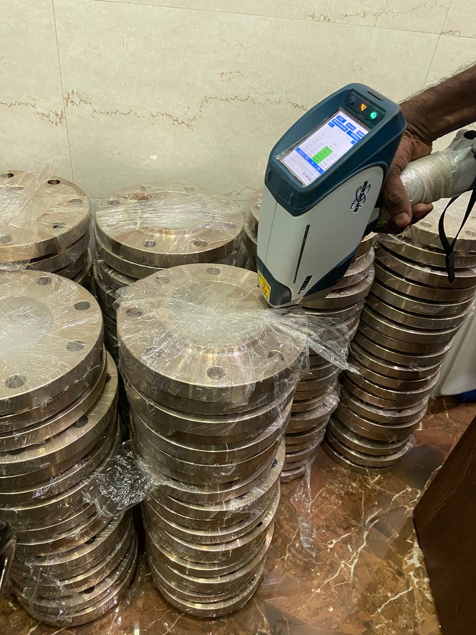 Positive Material Identification PMI testing of Copper Nickel flanges using portable XRF analyser to verify Cu-Ni composition