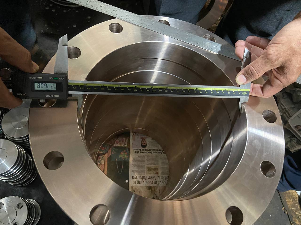 Quality inspection of Copper Nickel weld neck flange bore diameter measured at 809 mm with digital vernier caliper