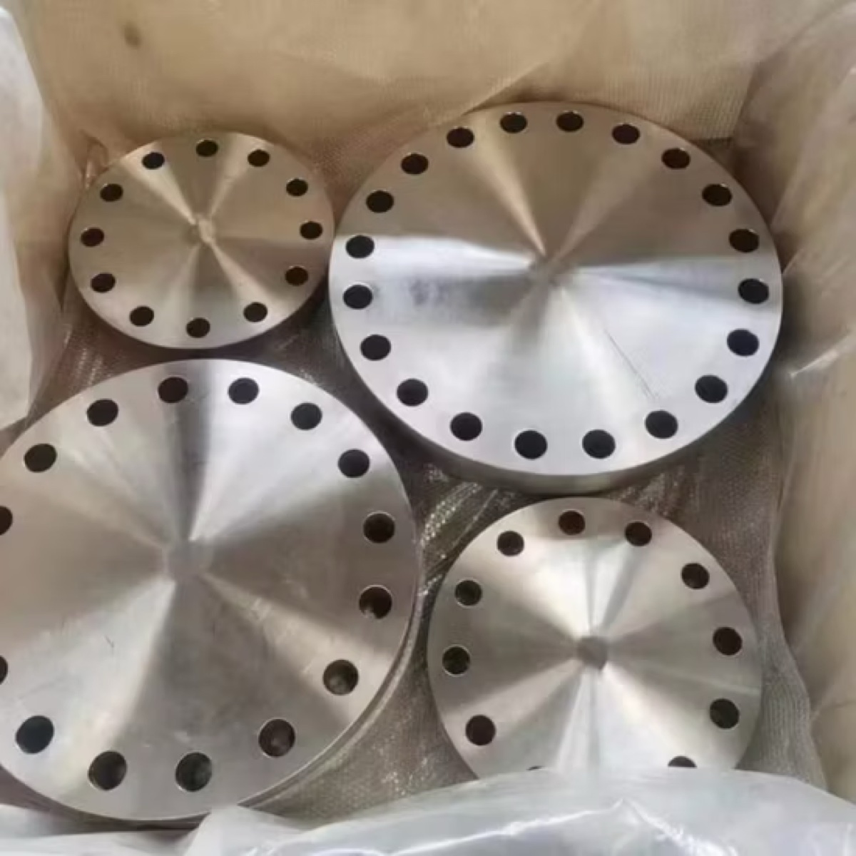 Forged blind flanges of assorted sizes packed in lined wooden export crate