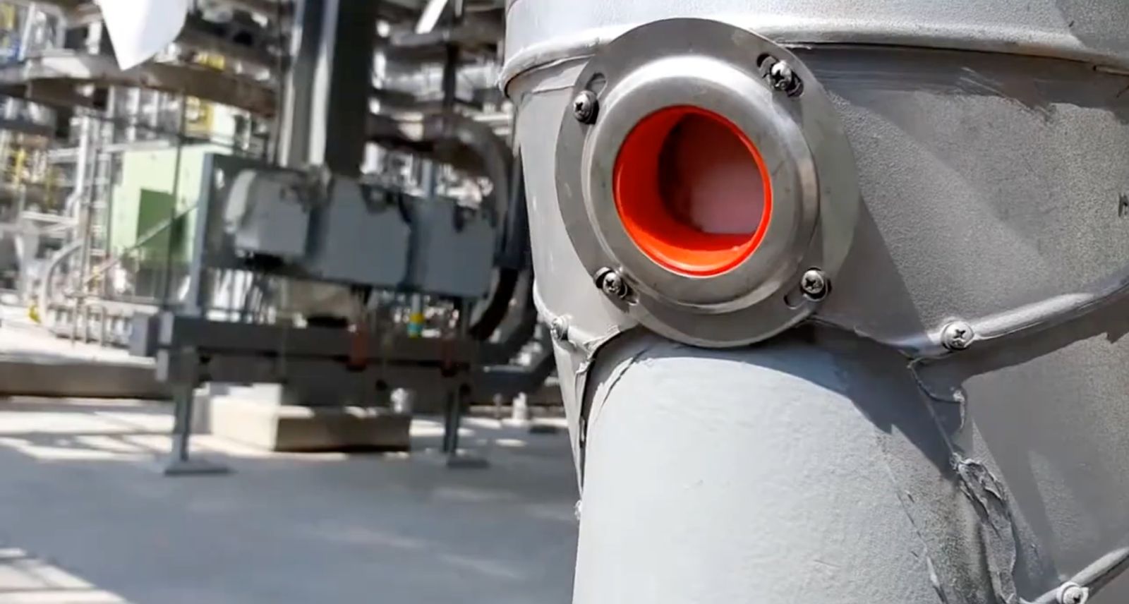 Insulation inspection plug installed on insulated vessel cladding at a refinery — resealable CUI inspection port through metal jacketing