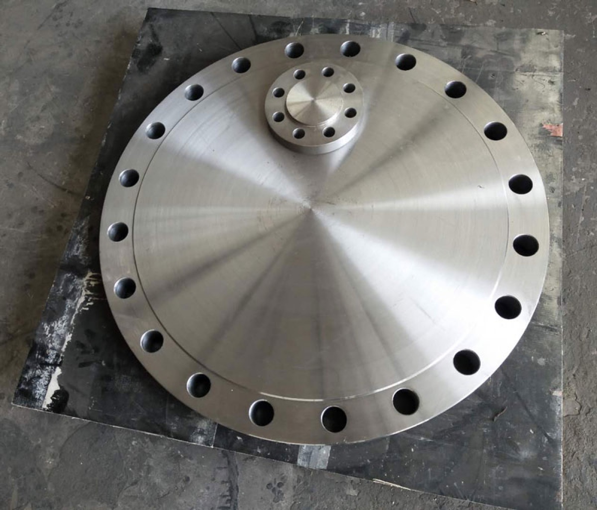 Large machined forged blind flange with small auxiliary nozzle flange connection on the face
