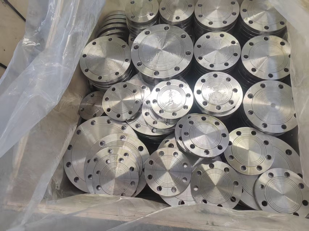 Stainless steel blind flanges of assorted sizes packed in lined wooden export crate