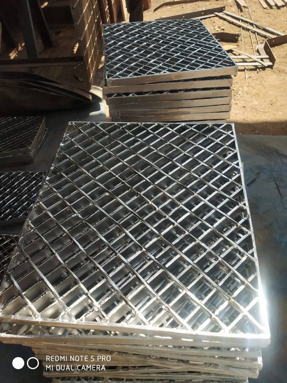 Welded steel grating serrated anti-slip panels stacked — Tesco Steel & Engineering